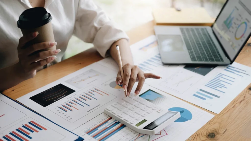 Small business owner reviewing financial report with bookkeeping services
