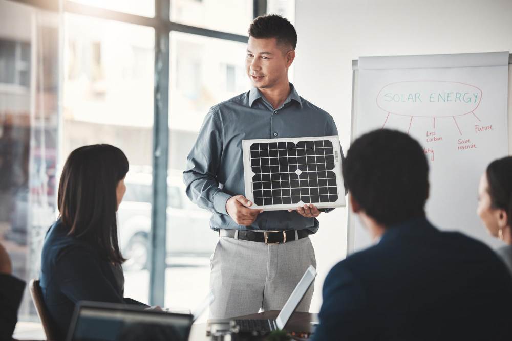 A sales representative with a small solar panel