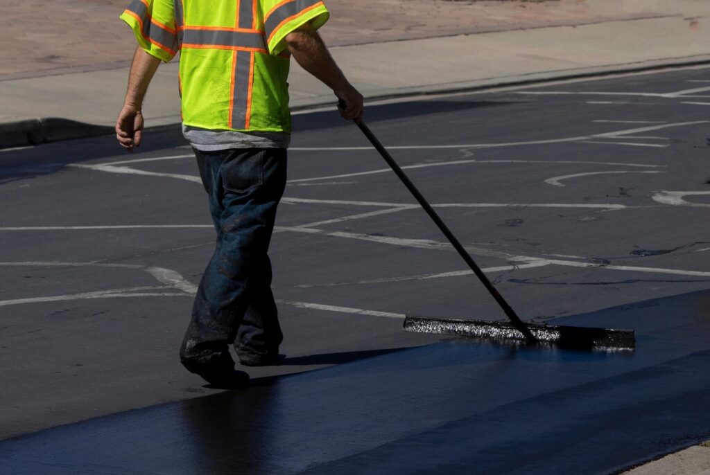 Sealcoating Ellijay GA applied to a smooth asphalt driveway by professional contractors