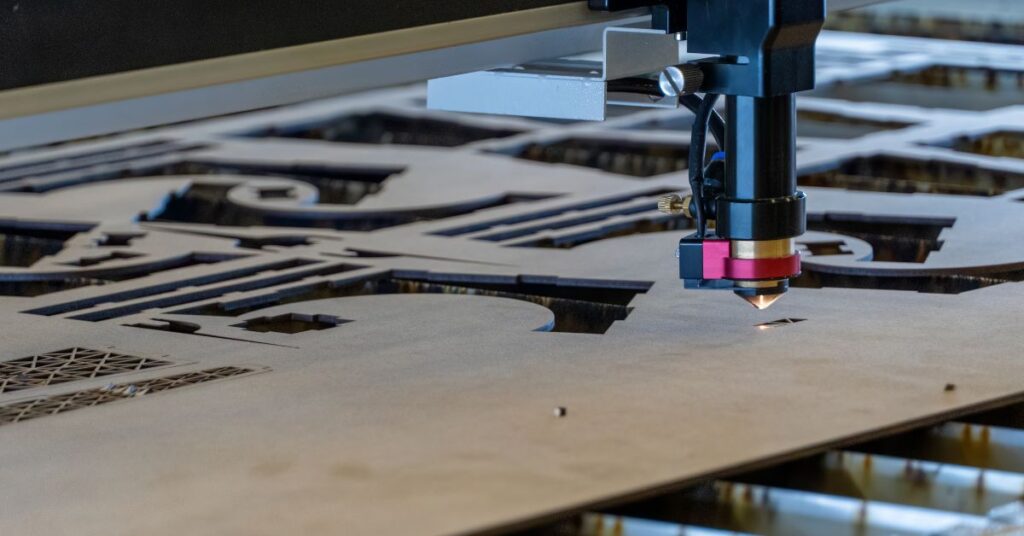 Close-up of a laser cutting machine creating detailed patterns on wood for precision woodworking projects